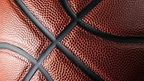 Close up shot of rotating basketball ball on dark black background. Stock Footage