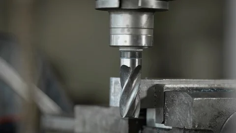 Close-up shot of a rotating drilling bit on machine in a industrial facility. Stock-Footage 94994687
