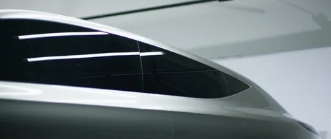 Close Up shot of a rotating luxury silver car in a bright studio Stock Footage 126530993