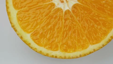 Close up shot of rotating one slice of orange Stock Footage 138895078
