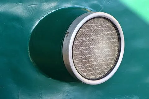 A close-up shot of a round window on a green wall, perfect for interior design Stock Photos