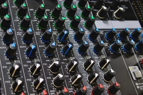 Close-up shot of rows of control knobs and buttons on a digital multi effec.. Stock Photos