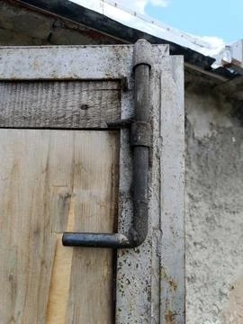 Close-up shot of a rustic, handmade metal slide latch locking a weathered w.. Stock Photos