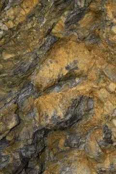 A close up shot of an rustic orange rock. Stock Photos