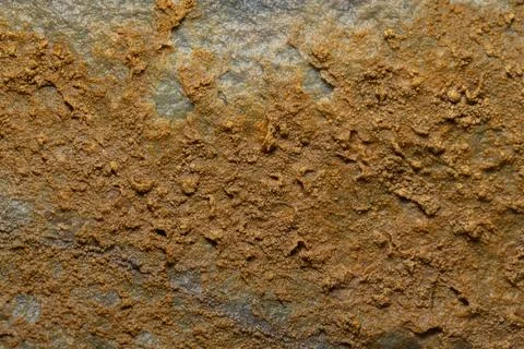 A close up shot of an rustic orange rock. Stock Photos