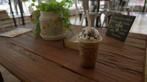 A close up shot of a rustic wooden table on an outdoor patio featuring Stock Footage 337229683