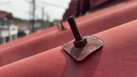 Close up shot on rusty bolted nut on red roof day at home residential, Thailand Stock Footage 234740408