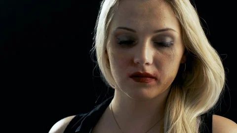 Close-up Shot Sad Crying Bruised Blonde Woman Looking Down Then Into Camera Stock Footage