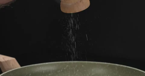 Close-up shot of salting red fish steak in a pan. Close-up, slow motion shot Stock Footage 250005906