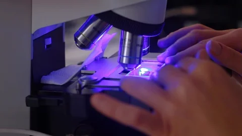 Close-up shot of sample slide and microscope with metal lens at laboratory Stock Footage 127285549