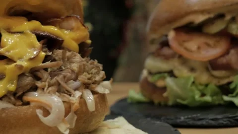 Close-up shot of sandwiches with pulled pork, sauces and melted cheddar cheese Stock Footage 263732383