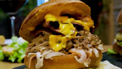 Close-up shot of sandwiches with pulled pork, sauces and melted cheddar cheese Stock Footage 263732515