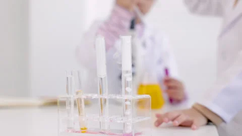 Close up shot of a science experiment in the school lab, drop of liquid in .. Stock Footage 243622047