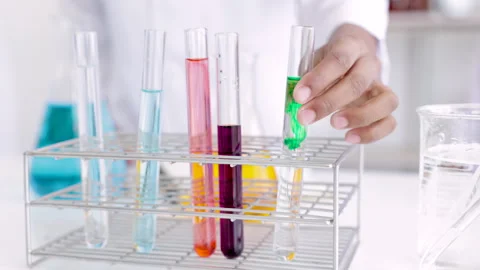 Close up shot of a science experiment in the school lab, drop of liquid in .. Stock Footage 243631616