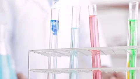 Close up shot of a science experiment in the school lab, drop of liquid in .. Stock Footage 243659960