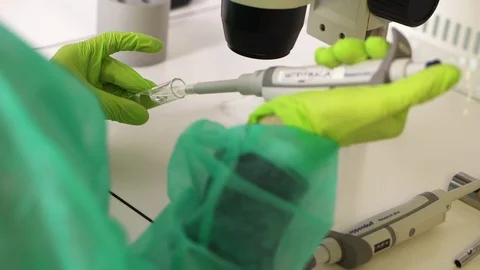 Close up shot of a scientist extracting liquid from a clear vial with a Stock Footage 96268392