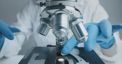 Close up shot of the scientist studies examining of test sample under the 库存影片 121616425