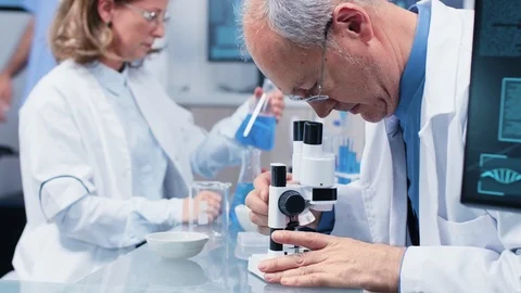 Close up shot of scientist working in busy laboratory Stock Footage 111057258