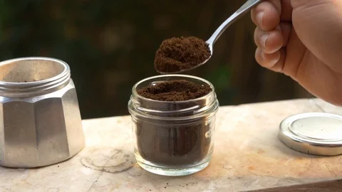 Close-up shot, scooping Ground Coffee from a glass jar. Stock Footage 126888962