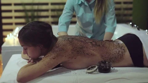 Close up shot of scrubbing with back massage elements with coffee granules. Stock Footage 73637878