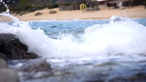 Close up shot of sea waves splashing on rocks. Video stock 112657479