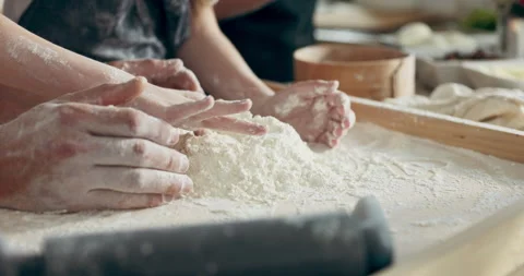 Close up shot selective focus on hands playing with flour on wooden board in Stock Footage 218629432