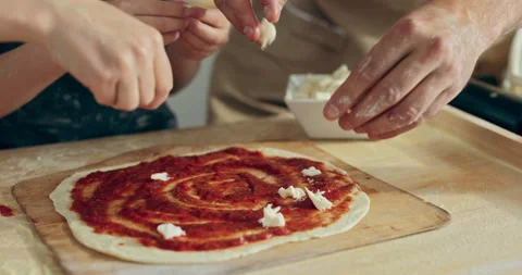 Close up shot selective focus on homemade pizza with tomato sauce. Families Stock Footage 218637872