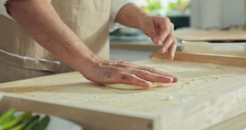 Close up shot selective focus on man's hands kneading pizza dough.Chef kneading Видео 218640255