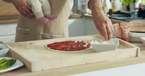 Close up shot selective focus on man's hands dressing pizza with cheese and 動画素材 218642022