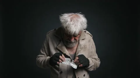 Close-up shot of a senior, gray-haired male counting his money Stock Footage 229233699