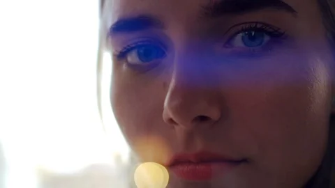 Close up shot serious face young attractive girl with blue eyes look at camera Stock Footage 99671052