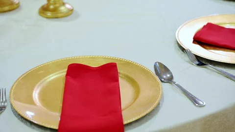 Close-up shot of served table in gold and red colors with the red napkin at Vidéo 310429332
