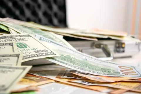 A close-up shot of several US dollar bills spread out on a white surface ne.. Stock Photos