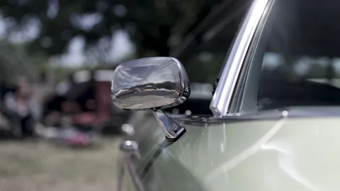 Close up shot of shiny side view mirror on a classic car Stock Footage 279526536