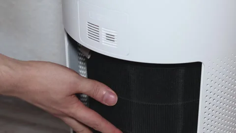 Close-up shot showing hands inserting a brand-new clean air filter into a w.. Stock Footage 314747471