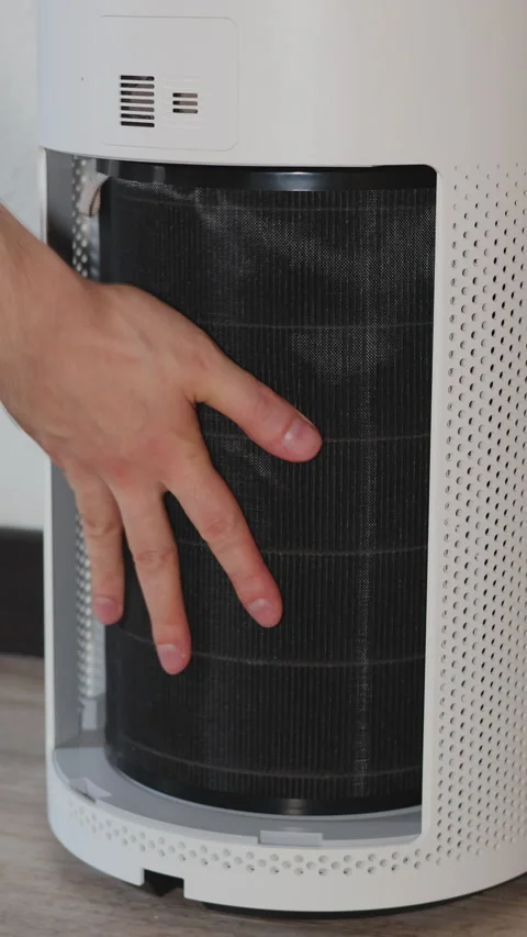 Close-up shot showing hands rea brand-new clean air filter into a white air.. Stock Footage 314747461