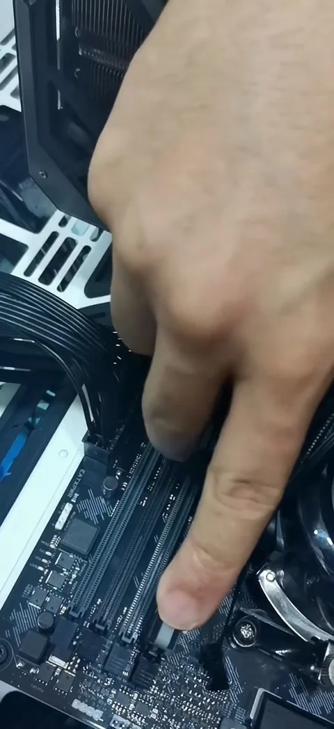 A close-up shot showing the installation of a DDR4 RAM stick into a motherboard Stock-Footage 333376186