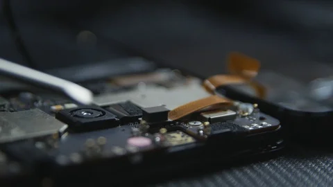Close-up shot showing the process of cell phone repairing. Hands of repairer  Видео 113398346