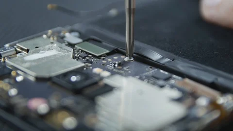 Close-up shot showing the process of cell phone repairing. Hands of repairer  Stockbeeldmateriaal 113398384
