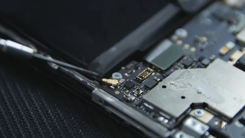 Close-up shot showing the process of cell phone repairing. Hands of repairer  Stock Footage 113398417