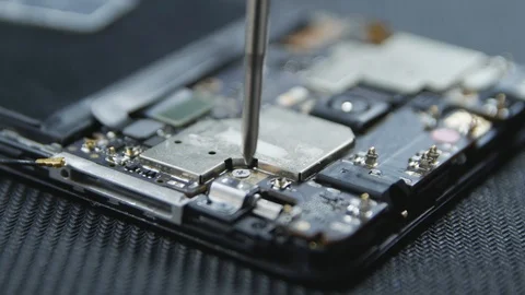 Close-up shot showing the process of cell phone repairing. Hands of repairer  Stock Footage 113398454