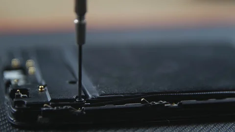 Close-up shot showing the process of cell phone repairing. Hands of repairer  動画素材 113398601