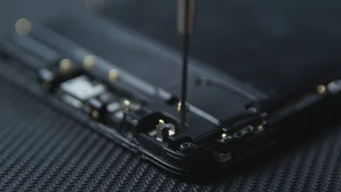Close-up shot showing the process of cell phone repairing. Hands of repairer  Видео 113398669