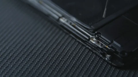 Close-up shot showing the process of cell phone repairing. Hands of repairer  Stockbeeldmateriaal 113398765