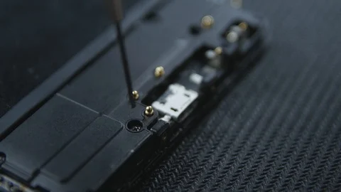 Close-up shot showing the process of cell phone repairing. Hands of repairer  Stockbeeldmateriaal 113398791