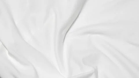 Close up shot showing the subtle texture and soft folds of a white fabric sur Stock Photos