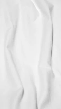 Close up shot showing the subtle texture and soft folds of a white fabric sur Stock Photos
