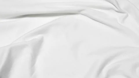 Close up shot showing the subtle texture and soft folds of a white fabric sur Stock Photos