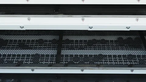 A close-up shot shows multiple layers of industrial metal screens or sieves Stock Footage 339911086