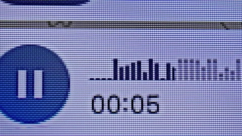A close-up shot shows a phone screen displaying a voice message interface. The Stock Footage 330607473